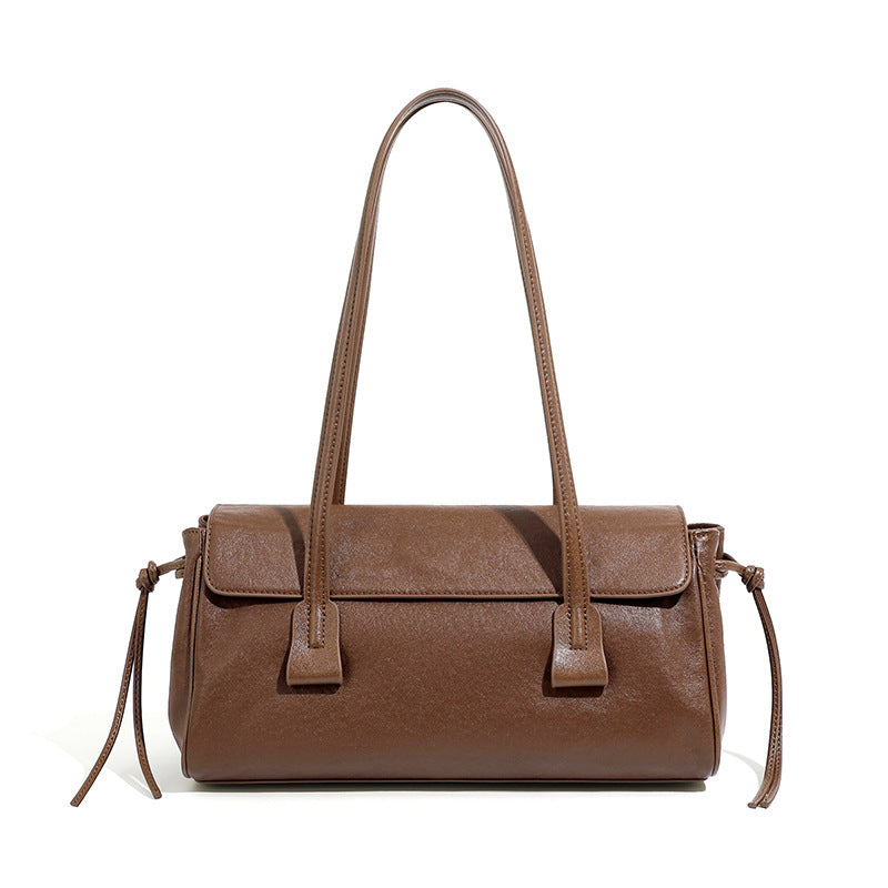 Brown handbag with shoulder strap on a white background