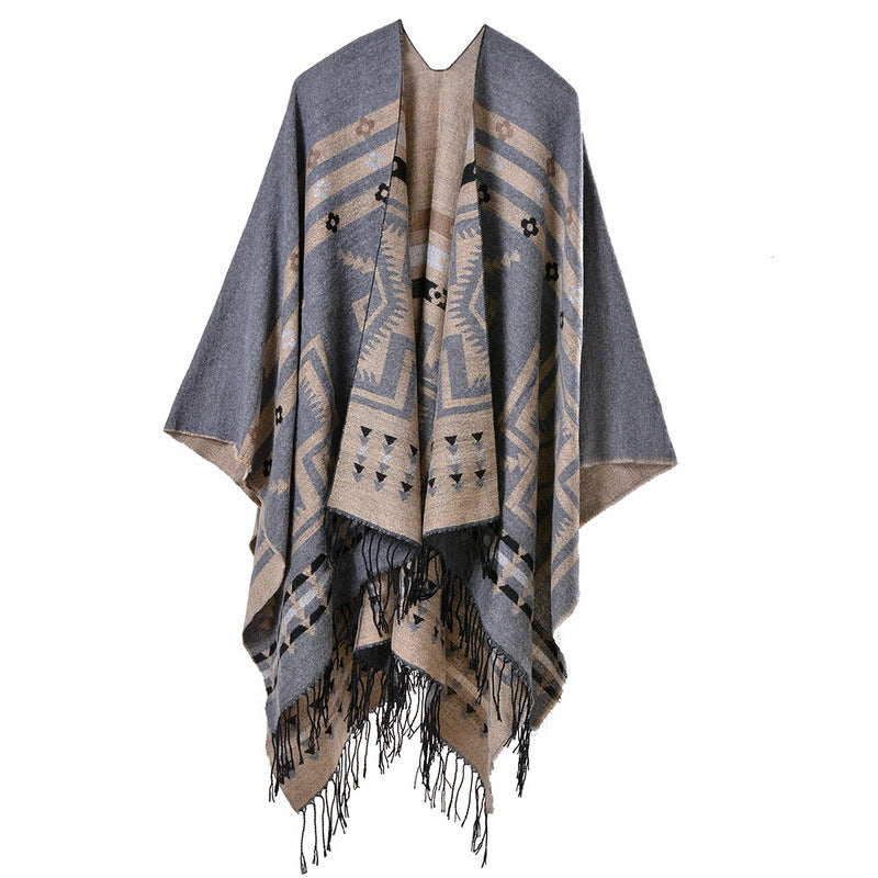 Gray and beige patterned poncho with fringes on a white background
