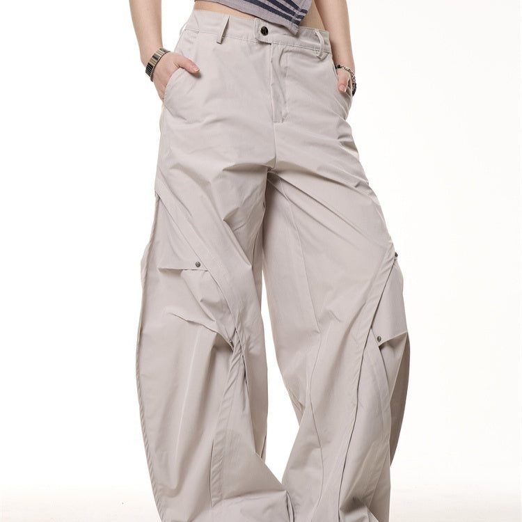 Beige wide-leg pants worn by a person on a white background