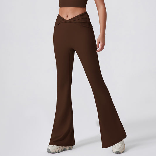 Brown flared pants worn by a person on a white background