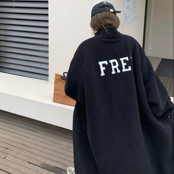 Person wearing a black hoodie with 'FRE' on the back, standing in a modern indoor setting.