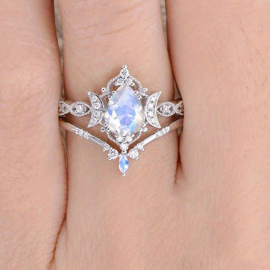 Silver ring with gemstone on a hand, featuring 'Real Sterling Silver 925' stamp.