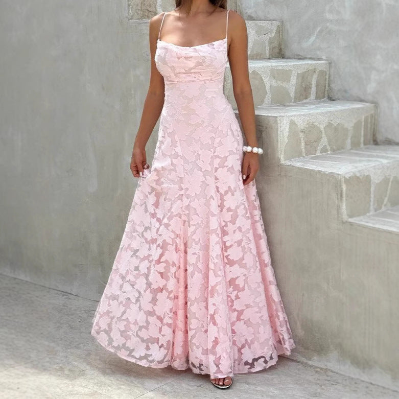 Pink lace dress worn by a person standing on a staircase.