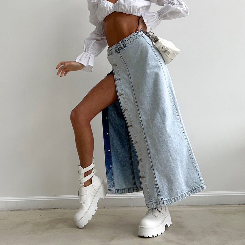 Person wearing a white blouse, denim skirt, and white platform boots against a plain background