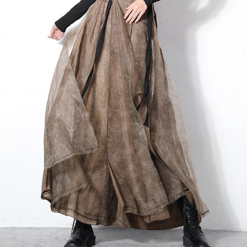 Long brown skirt with black accents on a plain background