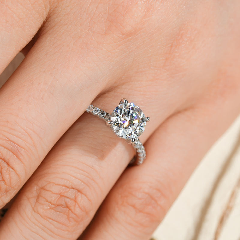 Diamond ring on a finger with a soft background