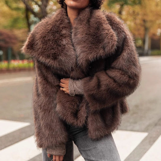 Person wearing a brown fur coat with a blurred outdoor background