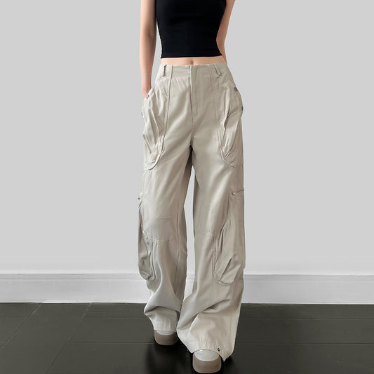 Person wearing beige cargo pants against a plain background