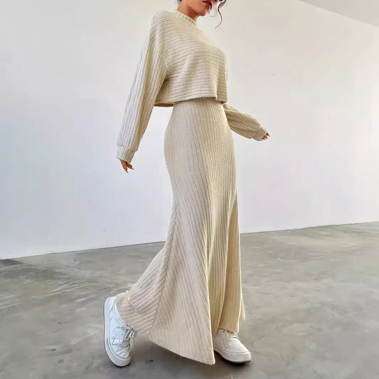 Person wearing a beige ribbed knit outfit with white sneakers in a minimalistic setting
