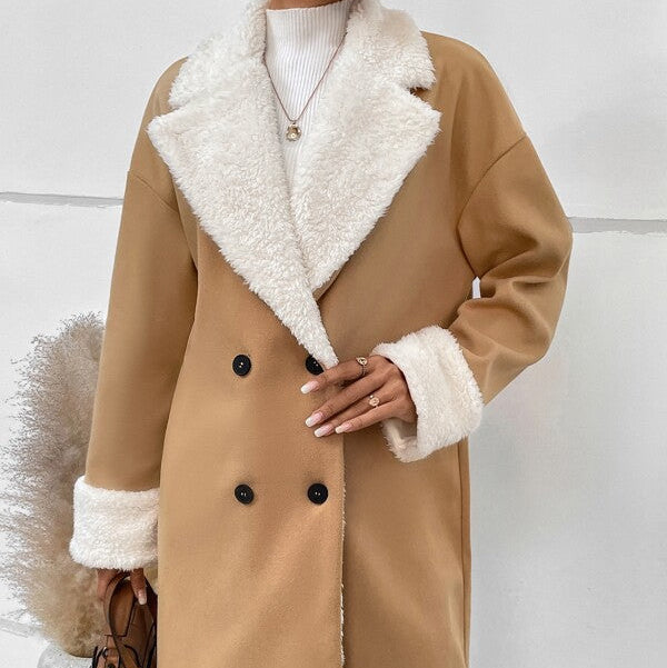 Tan coat with white fur lining worn by a person against a white background