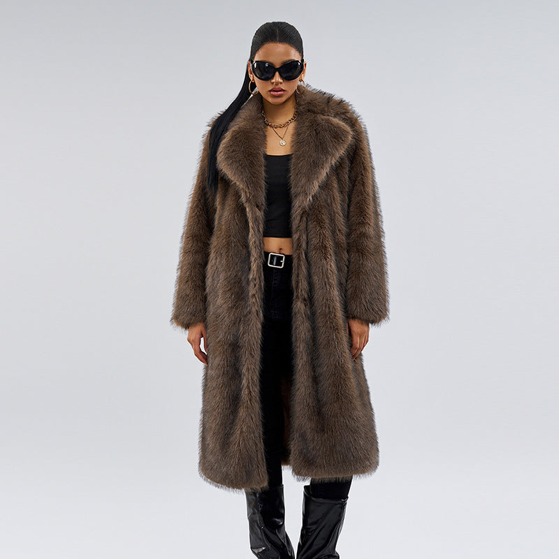 Woman wearing a long brown fur coat on a gray background