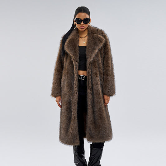 Woman wearing a long brown fur coat on a gray background