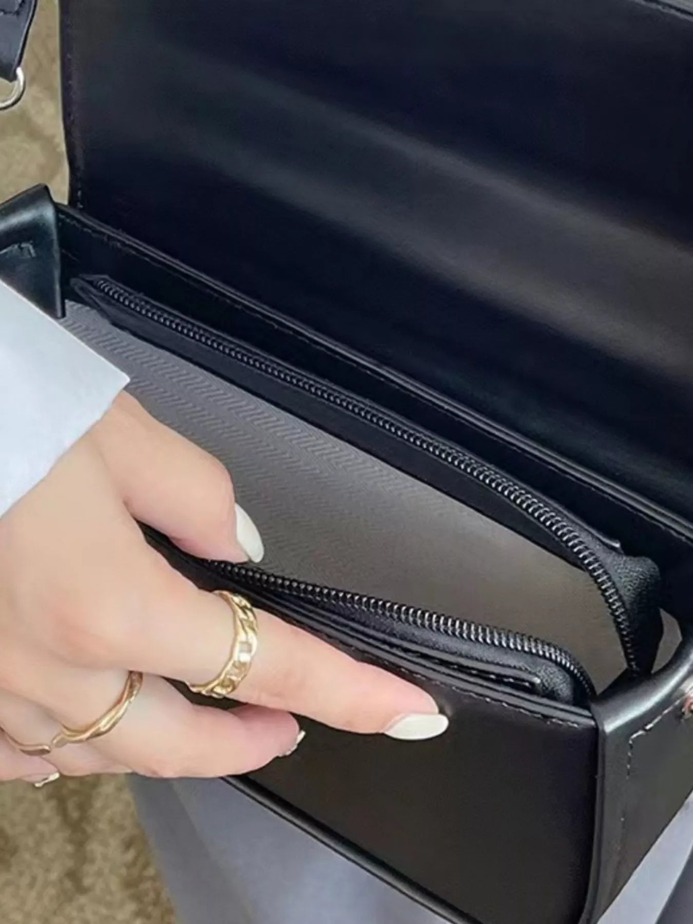 Close-up of the flap closure and smooth vegan leather finish