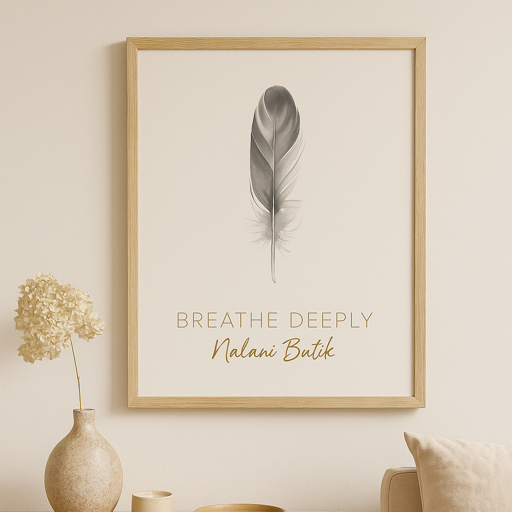 Framed artwork with a feather and text on a wall above a wooden table with decorative items.