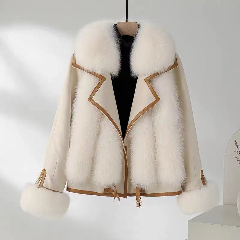 White fur coat with brown accents on a mannequin against a white background