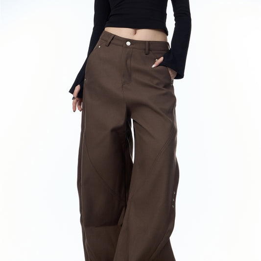 Brown pants worn by a person on a white background