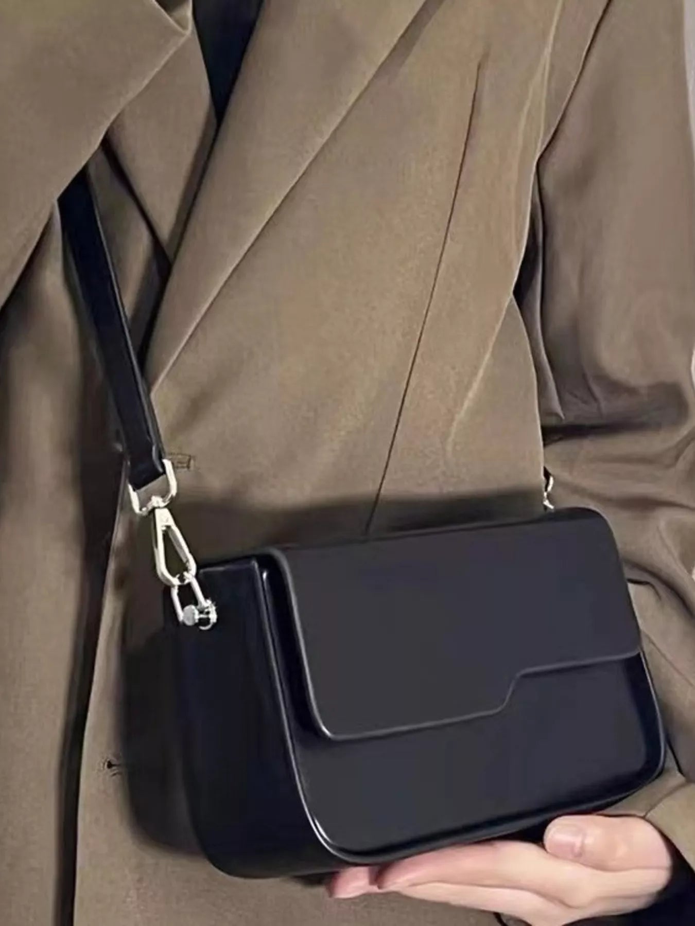 Black vegan leather crossbody bag with adjustable strap