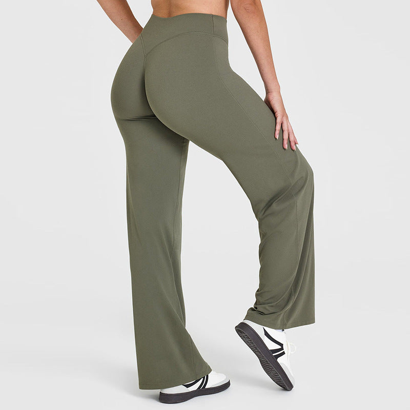 Person wearing olive green wide-leg pants on a white background