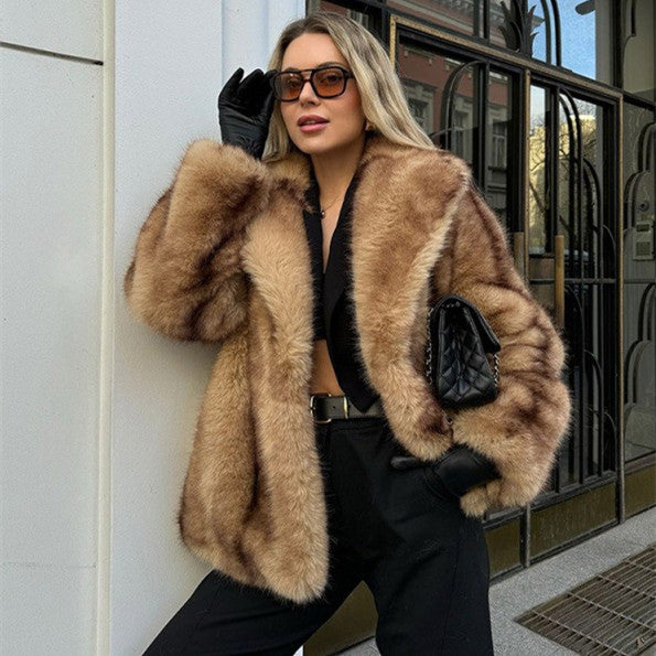 Woman wearing a fur coat and sunglasses standing against a building.