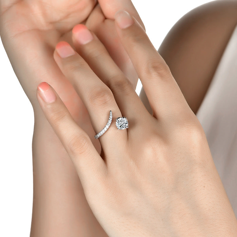 Close-up of a hand wearing two diamond rings on a white background