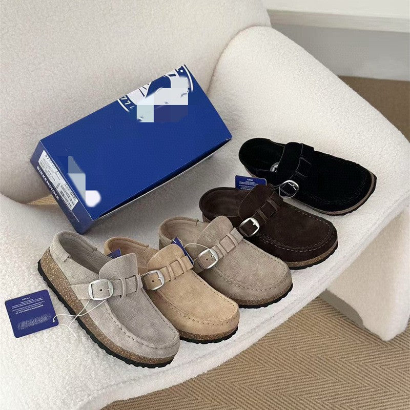 Set of suede clogs in various colors with a blue box on a white surface.