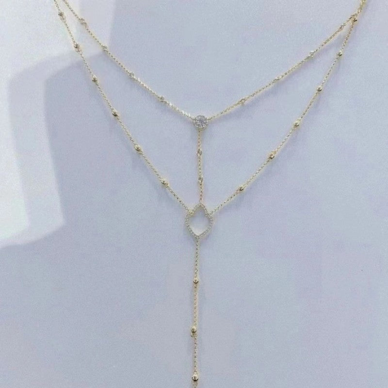 Gold necklace on a mannequin with a white background