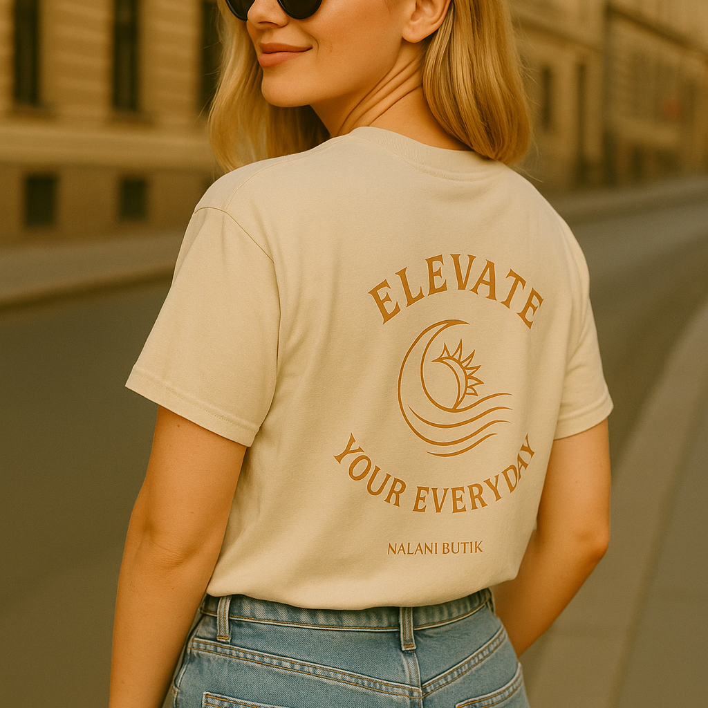 Woman wearing a beige t-shirt with 'Elevate Your Every Day' text, standing on a street.