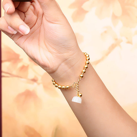 Hand holding a small brown cup with a blurred floral background