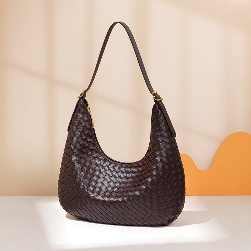 Brown woven handbag on a beige background