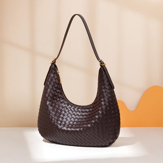 Brown woven handbag on a beige background