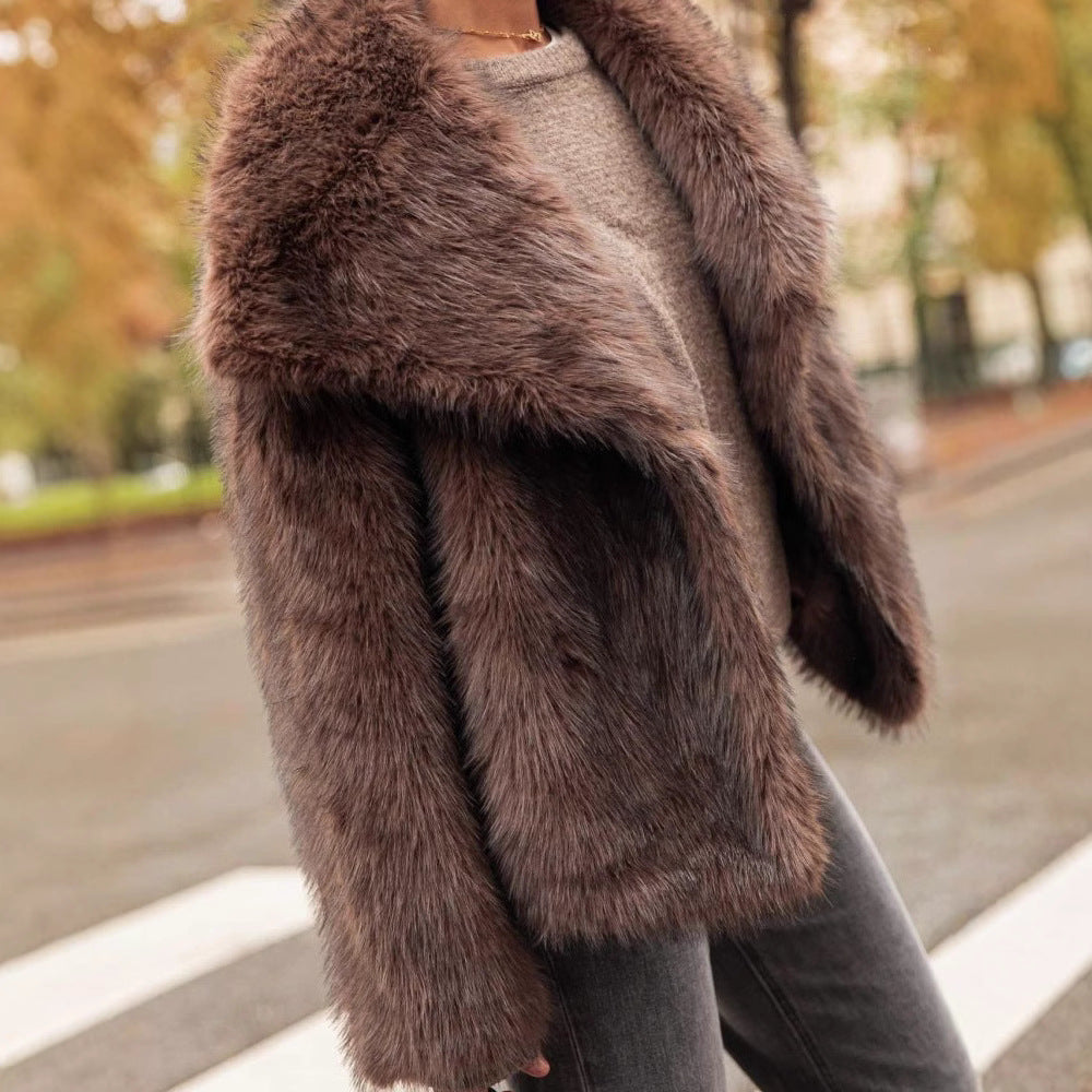 Brown fur coat worn by a person with a blurred outdoor background