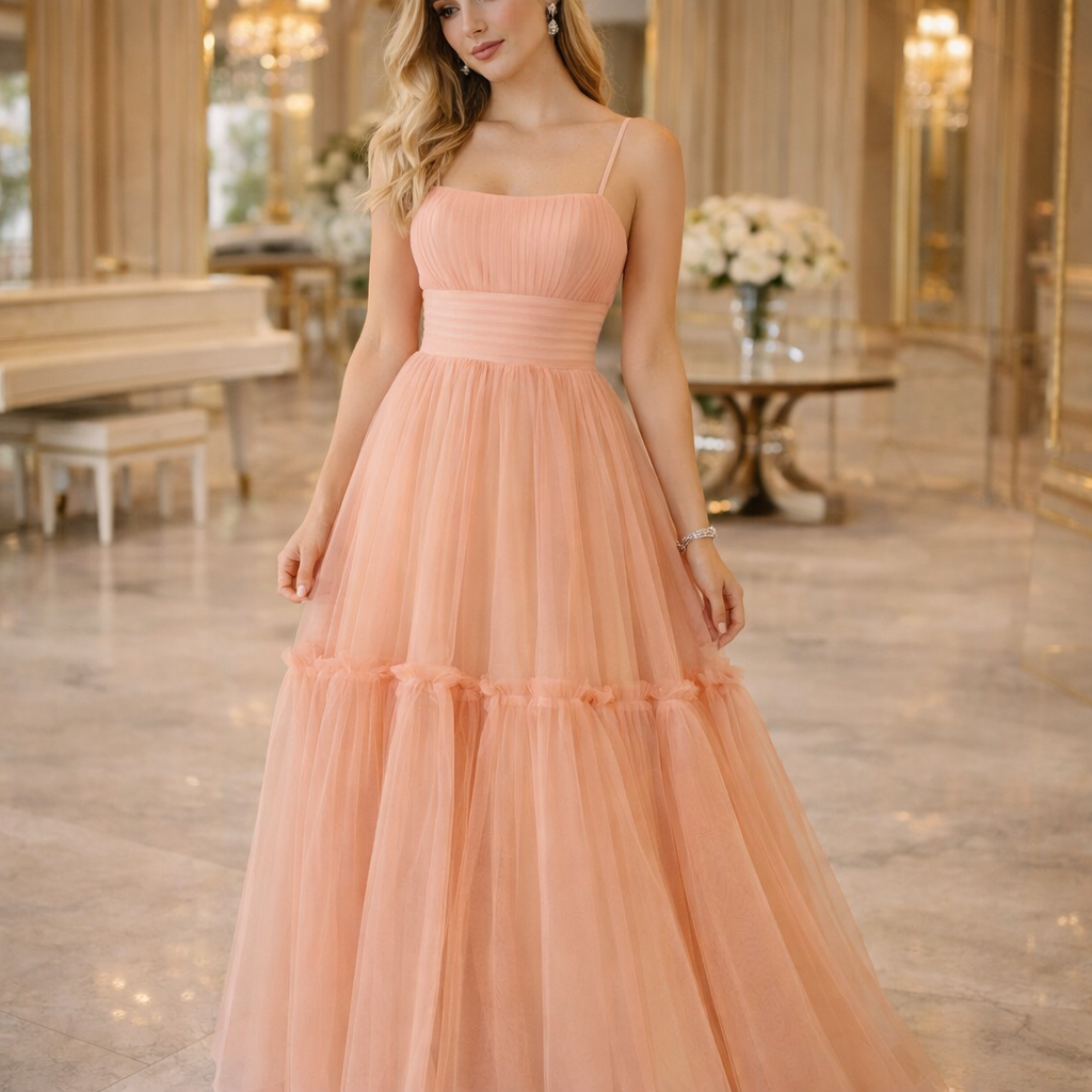Woman wearing a peach-colored dress in an elegant indoor setting